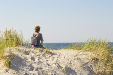 young girl by the sea looking into the distance