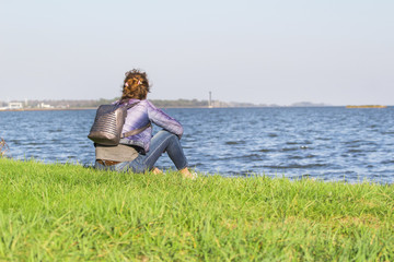 young girl by the sea looking into the distance