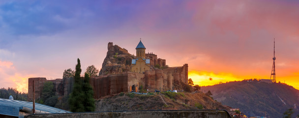 Amazing panoramic view of Narikala ancient fortress with St Nicholas Church at gorgeous sunset, Tbilisi, Georgia.