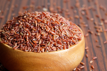 Red rice in wooden bowl