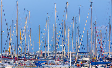 Masts of sailboats at sunset