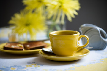 Classic American tableware with tea and toast on a vintage tablecloth.