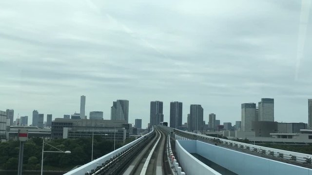 The train of the automated monorail guideway transit system (AGT) called the Yurikamome enter into the station in Tokyo