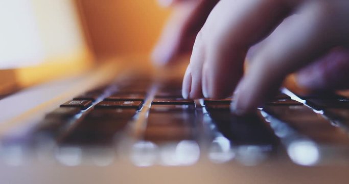 Typing on Keyboard CLOSE UP. 4K SLOW MOTION, DCi. Woman fingers working on a computer keyboard at night. Technology in everyday life.