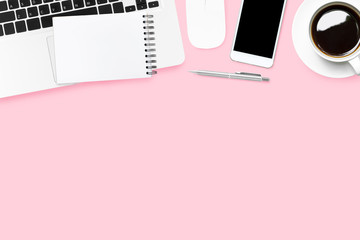 Pink pastel woman desk with laptop and supplies. Top view with copy space, flat lay.