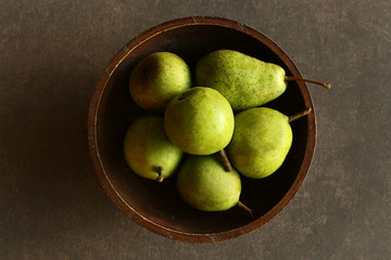 Green pears in plate top view. Fresh homegrown fruit pears.