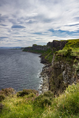 Fototapeta na wymiar Gorgeous Vertical view of the sea-cliffs of the Trotternish Peninsula across from Kilt Rock on the Isle of Skye in Scotland.