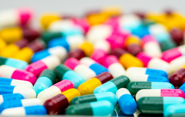 Fototapeta na wymiar Selective focus of antibiotic capsules pills on blur background, drug resistance concept.