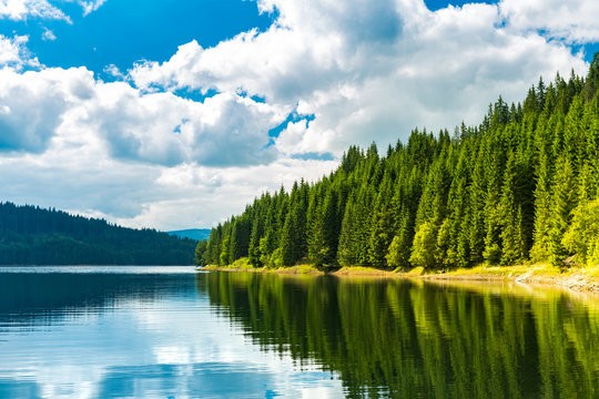 Vidra dam lake. Vidra Lake is a storage reservoir, located in the Parang Mountains, on the Lotru River, in Valcea County, Romania.