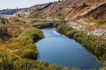 Fototapeta na wymiar a reservoir in an old quarry