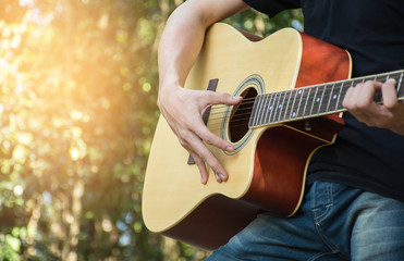 The men were caught playing guitar chords Relaxing Holiday Amid fresh Surrounded Forest
