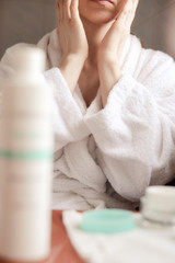 Obraz na płótnie Canvas Woman applying cream
