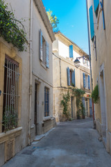 Fototapeta na wymiar Arles in the south of France, typical paved side street of the city center 