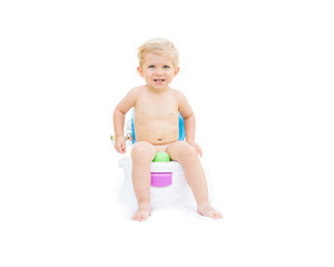 Infant boy, white caucasian smiling and sitting on the potty with white background.
 - obrazy, fototapety, plakaty