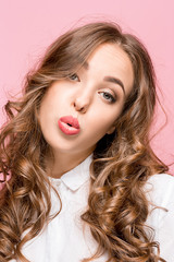 Woman is looking imploring over pink background
