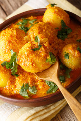 Indian fried potatoes Dum aloo in curry sauce close-up. verical