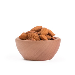 Bio organic almonds in wooden bowl isolated on white background.