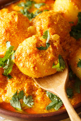 Freshly prepared spicy potato curry or Hot and spicy Dum aloo macro. Vertical