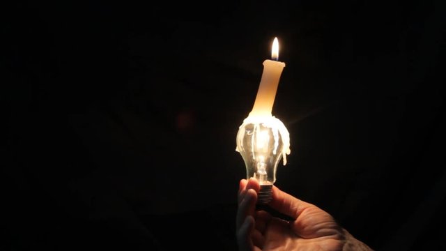 candle and lamp in hands of the person
light in a lamp depends on the lit candle
