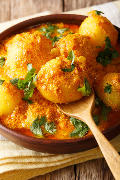 Spicy potato Dum aloo in curry sauce close-up. verical