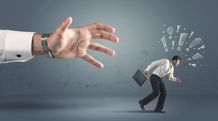 Business person getting away from a big hand