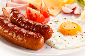     Breakfast - fried egg and sausages, cheese, ham and vegetables 