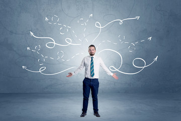Businessman standing with winding arrows around