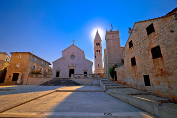 Square and church view in Supetar at sunset