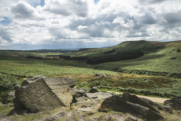 Beautiful vibrant landscape image of Burbage Edge and Rocks in Summer in Peak District England