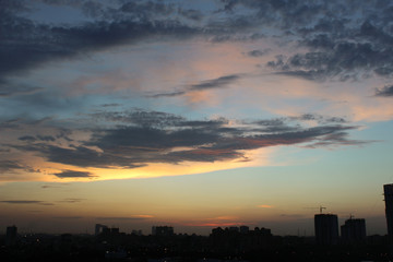 Cloudy colorful sun set in city