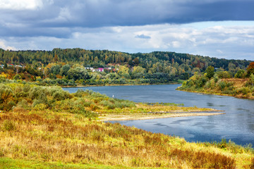 Fototapeta na wymiar Beautiful river bank, autumn landscape with dramatic sky
