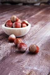 Hazelnut on wooden background. Tasty group of organic hazelnuts