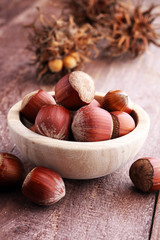 Hazelnut on wooden background. Tasty group of organic hazelnuts
