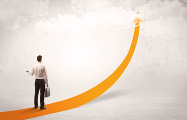 Business person standing on orange arrow