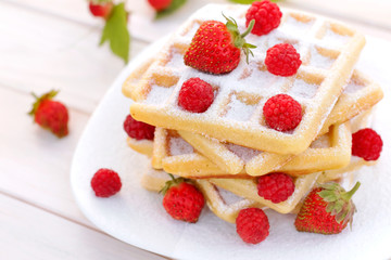 Belgian waffles with strawberries and raspberries.