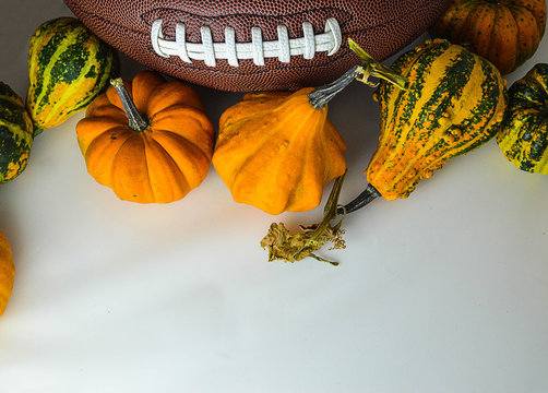 The ball for football with pumpkins on the white background. The picture is awesome for fall football game invitation card