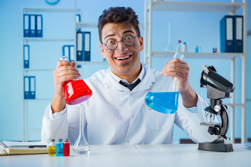 Funny mad chemist working in a laboratory