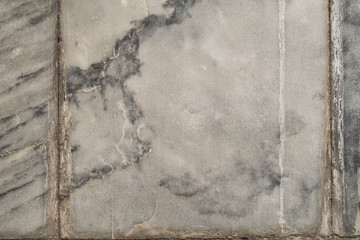 The texture of the brushed stone, marble. Different shades of gray with splotches, stripes, lines. Close-up.