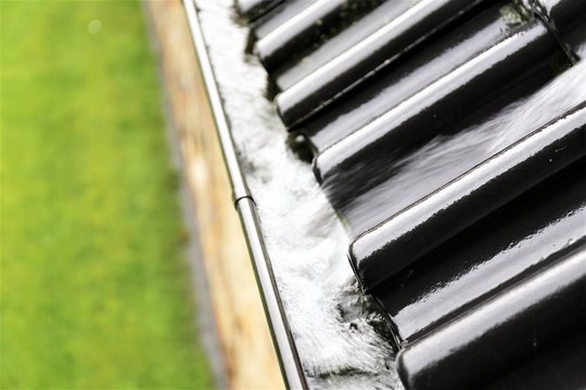 An image of a drain with raindrops 