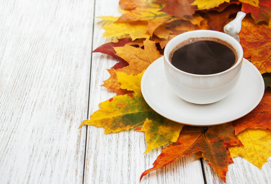 Cup of coffee and autumn leaves