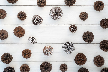 Christmas background. Christmas pine cones on white wood board. Creative Flat layout and top view composition