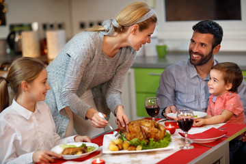 Female serving roasted turkey to her family