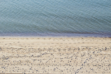 there are many footprints in the sand near the sea