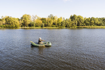 Fototapeta na wymiar Fisherman in the boat on the river