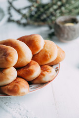 homemade pies with fish and mushrooms on a plate and wooden table