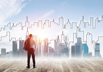 Motivation and inspiration concept with modern cityscape and businessman observing it