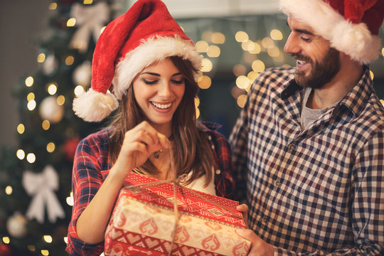 Man and woman opens Christmas gift