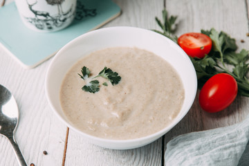 the soup with mushrooms on wooden background
