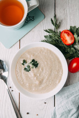 the soup with mushrooms on wooden background