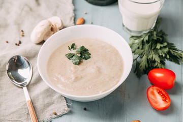 the soup with mushrooms on wooden background